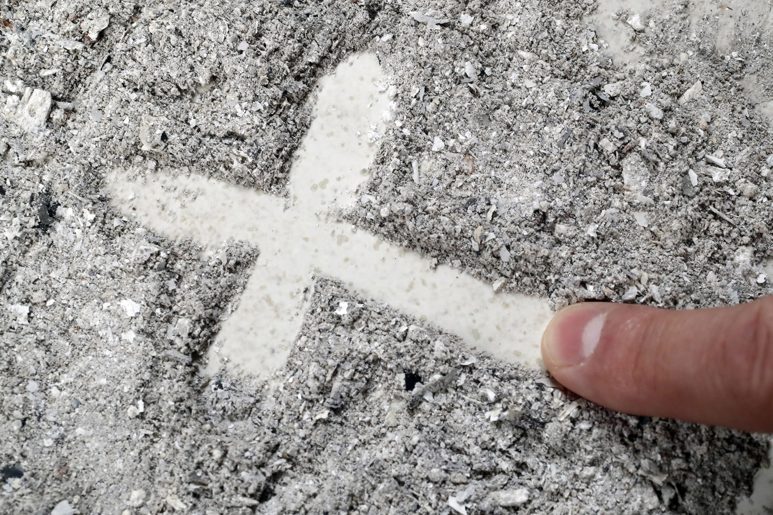 Cross made of ashes. Ash Wednesday. Lent season.